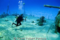 Wendy taking pix of the Shipwreck Tibbits in Cayman Brac.... by Kevin Robert Panizza 